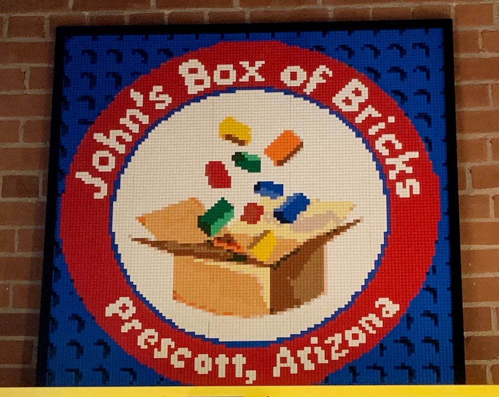 Pre-assembled brick mosaic sections packed in organised trays ready to hang