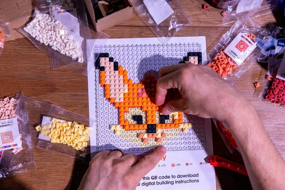 A recipient building a custom branded mosaic kit designed for a corporate gift