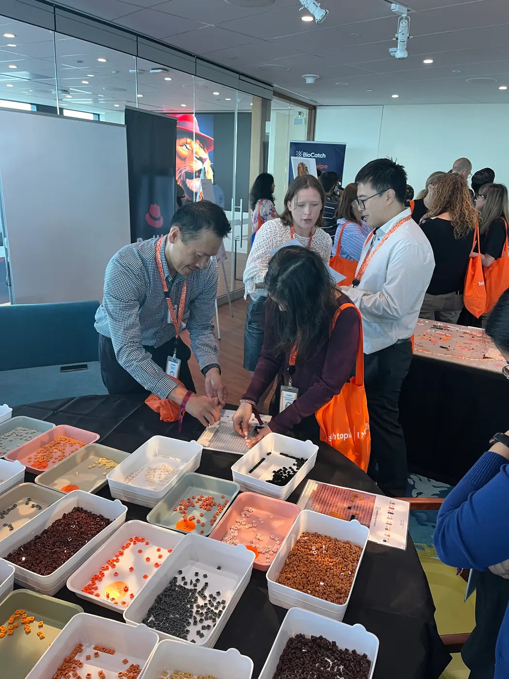 A corporate team building activity with brick mosaic kits across a room of tables